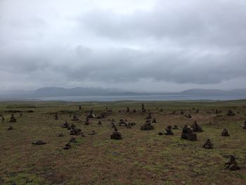 Scenic view of landscape against cloudy sky