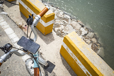 High angle view of text on road by water