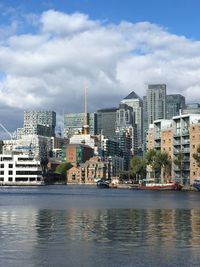 River by buildings against sky in city