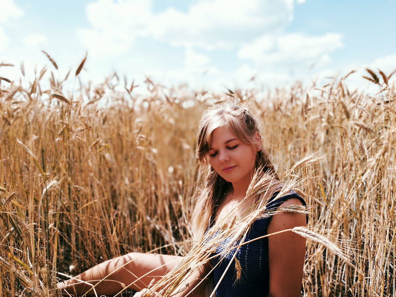one person, field, land, plant, real people, leisure activity, sky, young adult, young women, lifestyles, nature, agriculture, blond hair, women, beautiful woman, hair, day, beauty, crop, hairstyle, outdoors