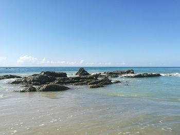 Scenic view of sea against clear blue sky