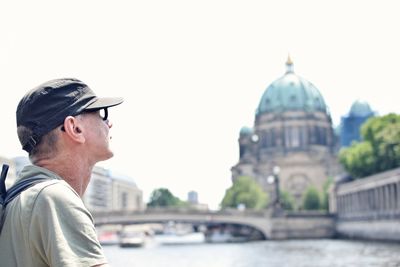 Mature man by river with berlin cathedral in background