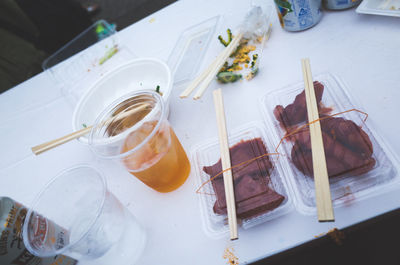 High angle view of meat with drink served on table