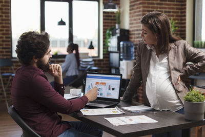 Business colleagues talking in office