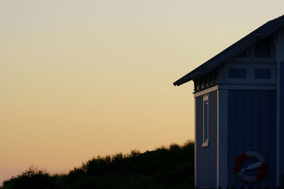 Silhouette house against sky during sunset