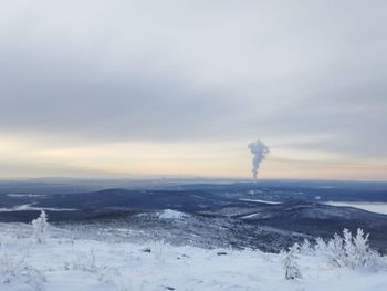 Scenic view of snow covered field against sky