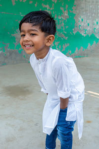 Portrait of smiling boy standing outdoors