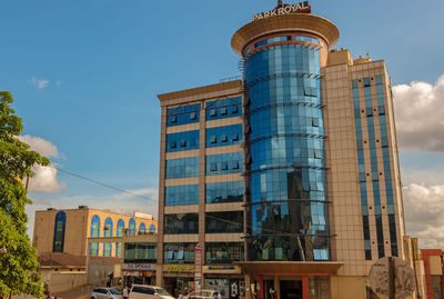 Low angle view of office building against blue sky