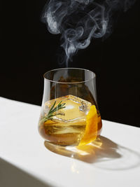 Close-up of drink on table against black background