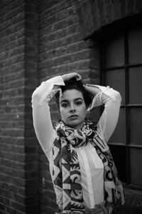 Portrait of girl standing against wall