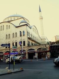 Buildings in city against clear sky