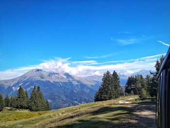 Scenic view of snowcapped mountains against blue sky