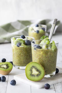 Kiwi pudding parfaits topped with vanilla yogurt, blueberries and kiwi.