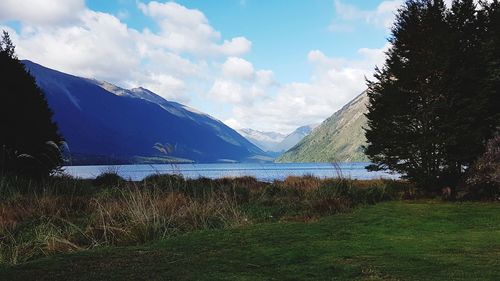 Scenic view of lake and mountains against sky