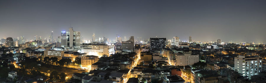 Aerial view of illuminated cityscape against sky