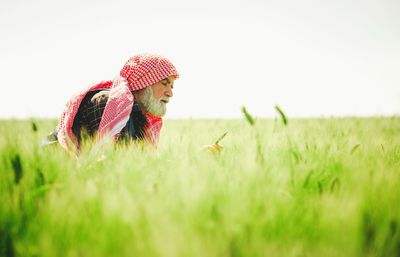 Woman looking at plants against sky