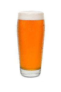 Close-up of beer glass against white background