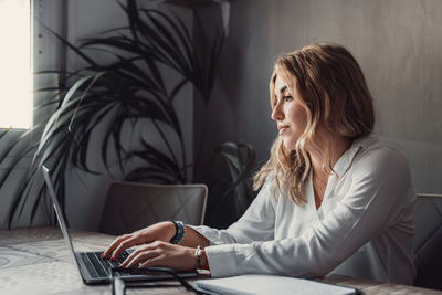 Young woman using laptop at home