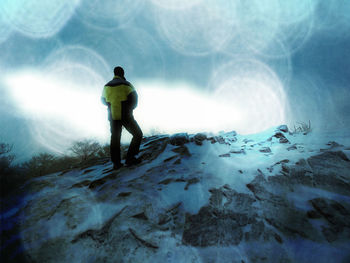 Rear view of man standing on snow