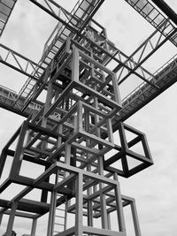 Low angle view of crane against sky