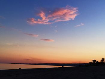 Scenic view of beach against sky during sunset