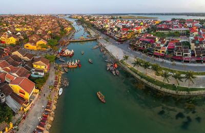 High angle view of buildings by sea against sky