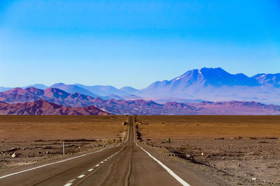 Empty road along countryside landscape