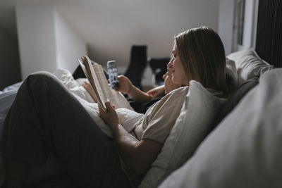 View of homosexual couple relaxing in bed together