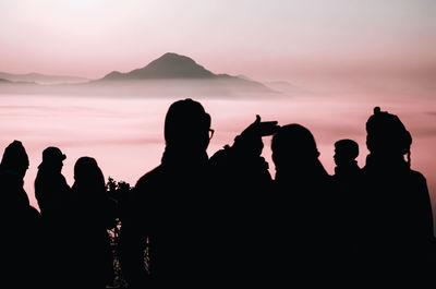 Silhouette people against sky during sunset