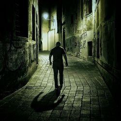 Full length of man walking in alley