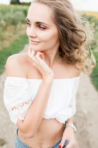 Portrait of young woman standing outdoors