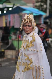 Portrait of mid adult man in traditional clothing standing on road