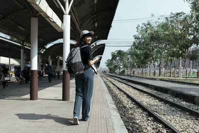 Man standing on railroad station platform