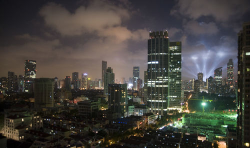 Illuminated cityscape against sky at night