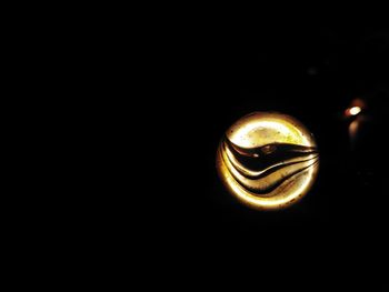 Close-up of electric lamp against black background