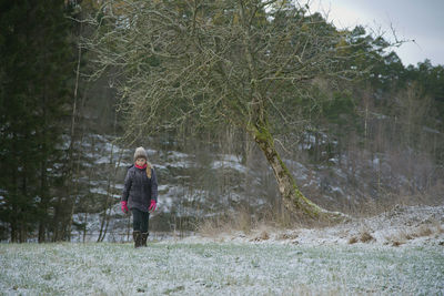 Girl walking on field during winter