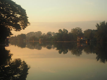 Scenic view of lake against sky at sunset