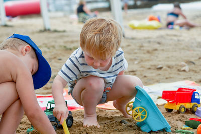 Boy playing with toy on beach