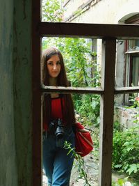 Portrait of woman seen through window