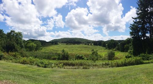 Scenic view of landscape against cloudy sky