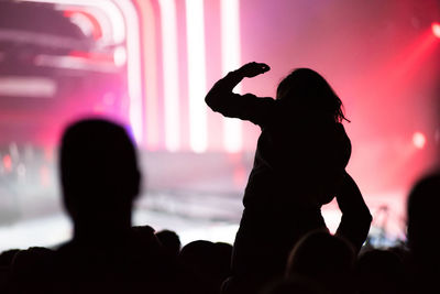 Silhouette people photographing at music concert