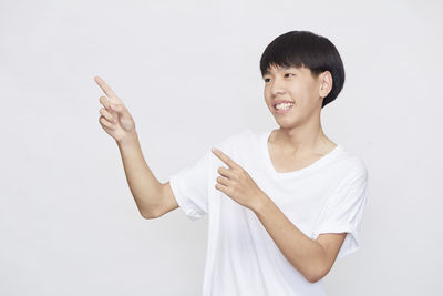 Portrait of smiling man standing against white background