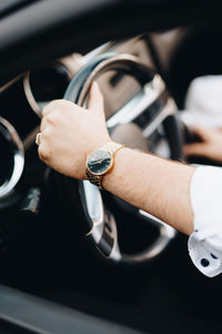 Close-up of hand holding eyeglasses in car