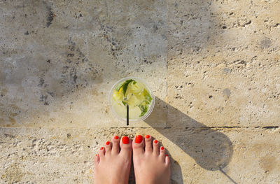 Low section of woman standing on floor