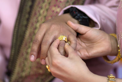 Couple exchanging rings during wedding ceremony