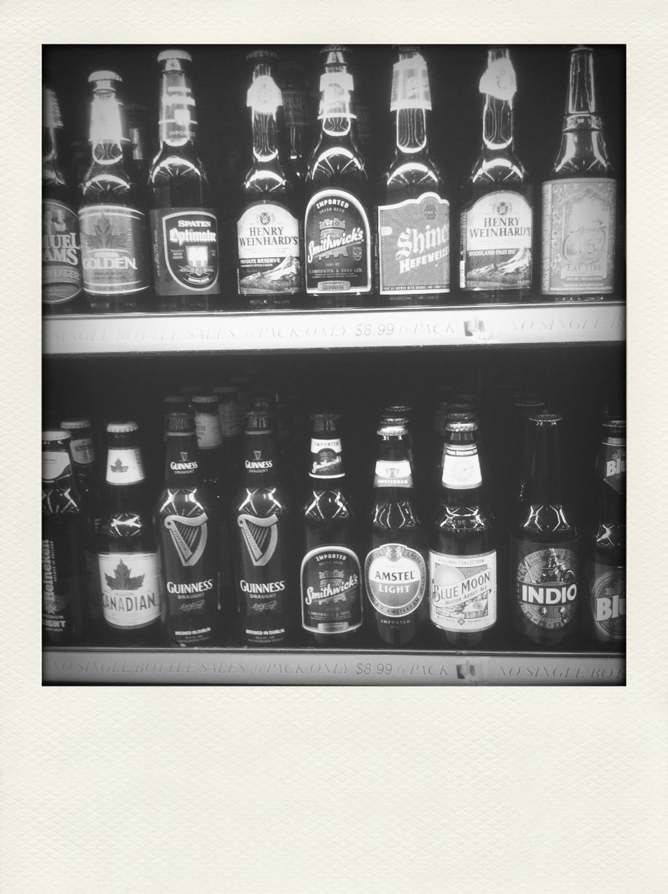 indoors, text, transfer print, arrangement, western script, large group of objects, shelf, still life, communication, auto post production filter, abundance, in a row, side by side, order, variation, glass - material, food and drink, choice, number, no people