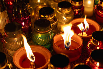 Serene candlelight in colorful jars at night memorial