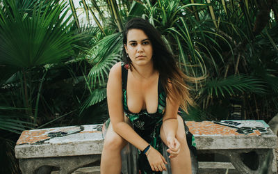 Portrait of young woman sitting outdoors