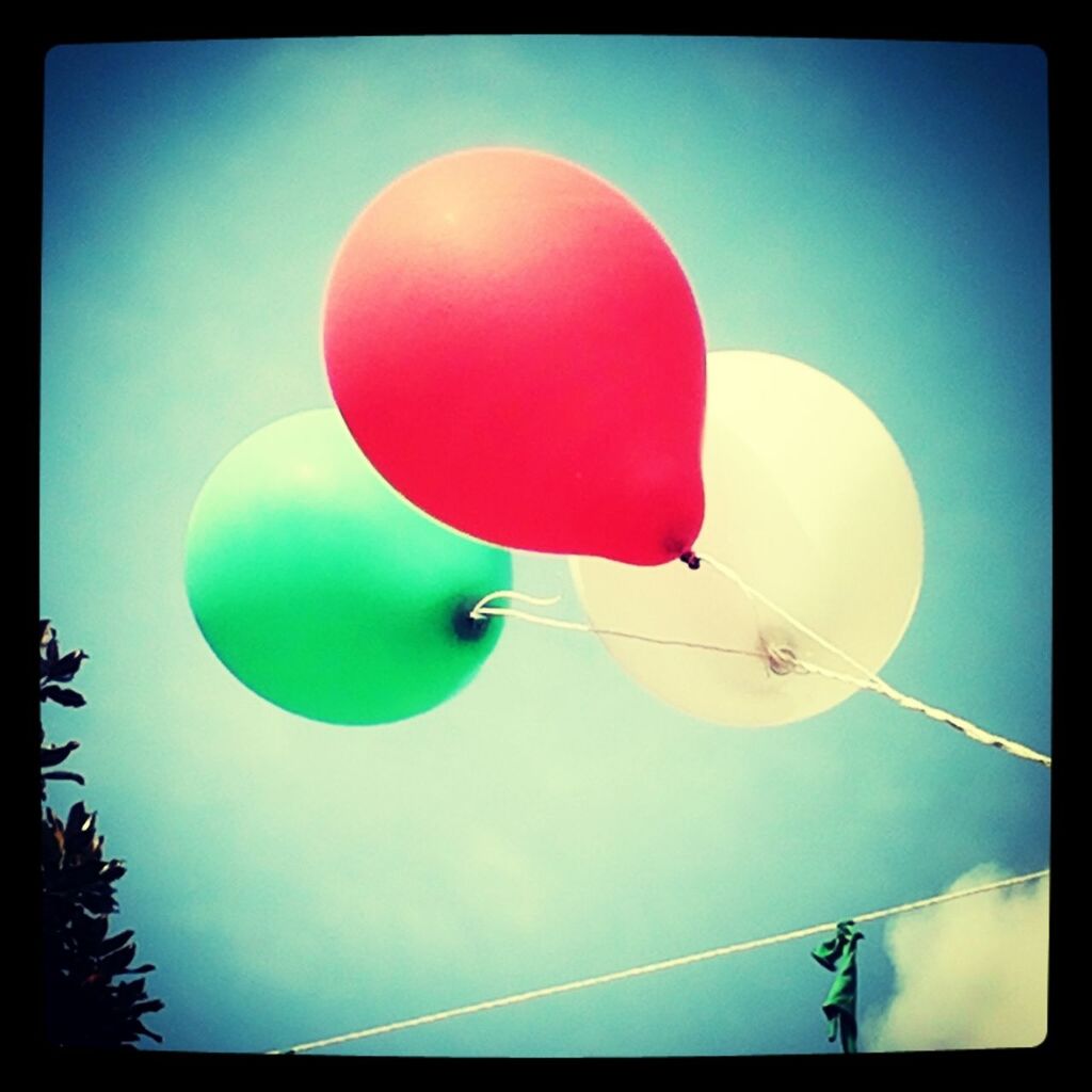 transfer print, low angle view, balloon, auto post production filter, multi colored, hanging, blue, sky, red, celebration, sphere, mid-air, clear sky, hot air balloon, lighting equipment, decoration, outdoors, no people, circle, sport