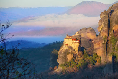 View of castle on mountain against cloudy sky